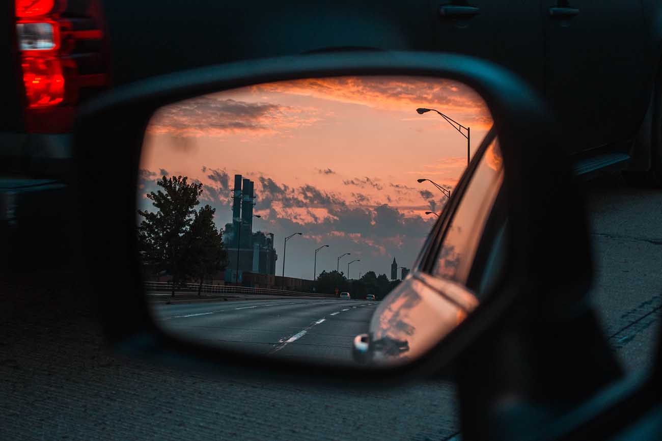 Side mirror of car with road