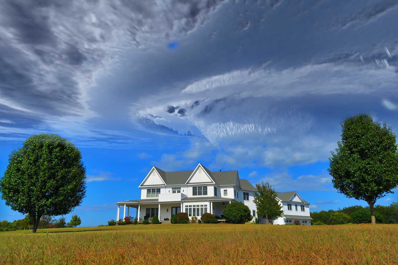 Farm home with clouds